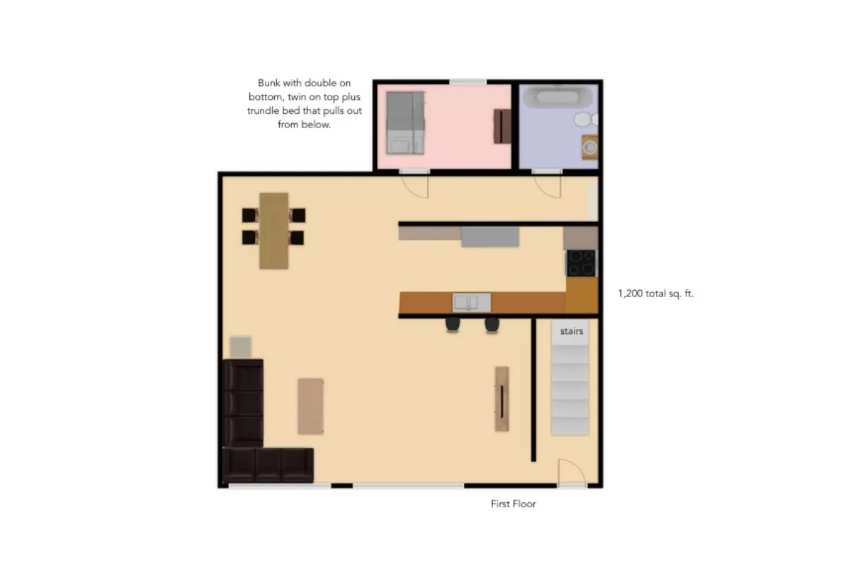 An open-plan living space features a cozy dining table, bunk bed, comfortable seating, and a kitchen island. The scene is lively and practical, ideal for family gatherings, meals, and relaxation, with thoughtful touches that cater to extended stays and group comfort.